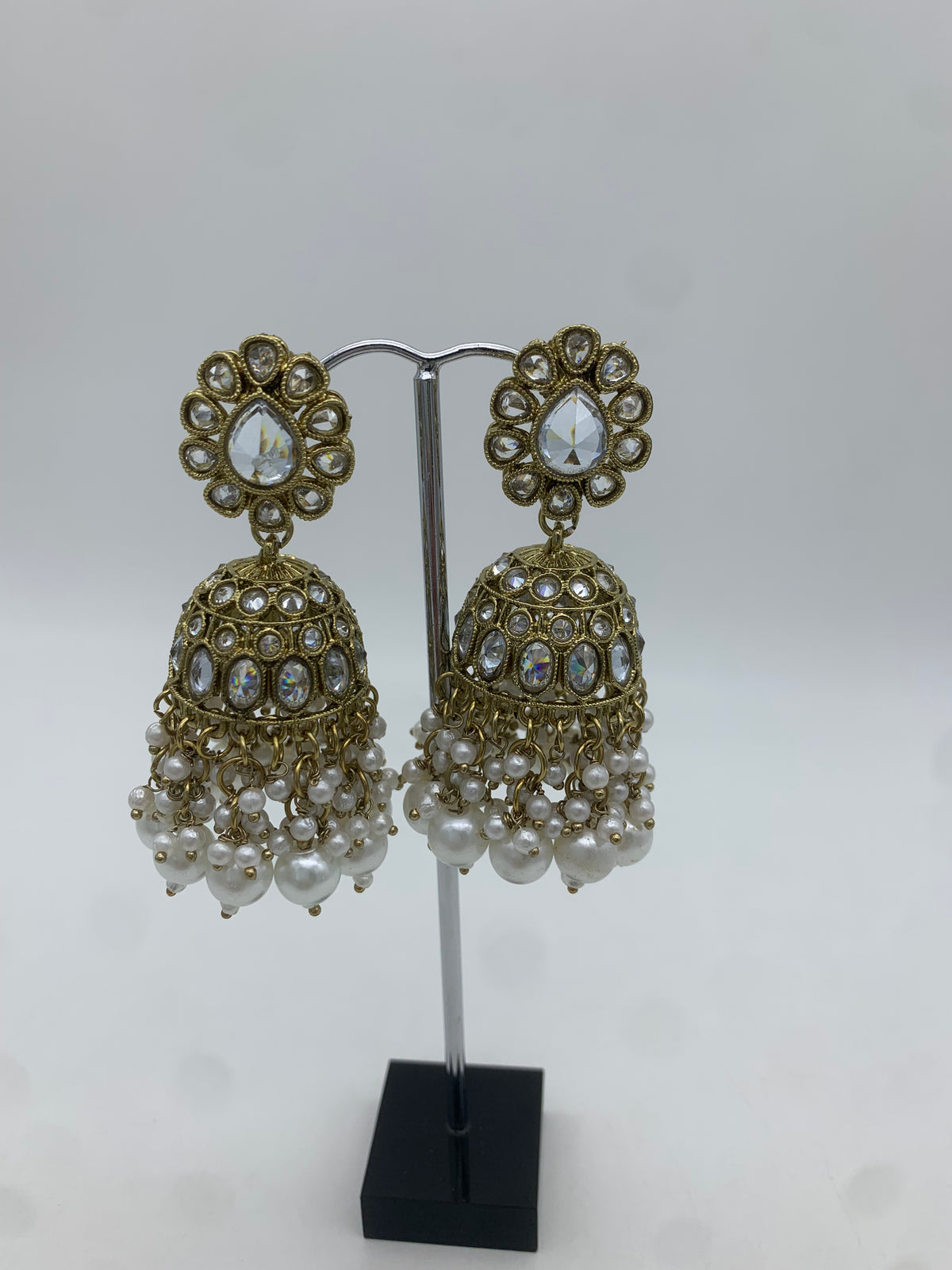 Gold and white jhumka earrings