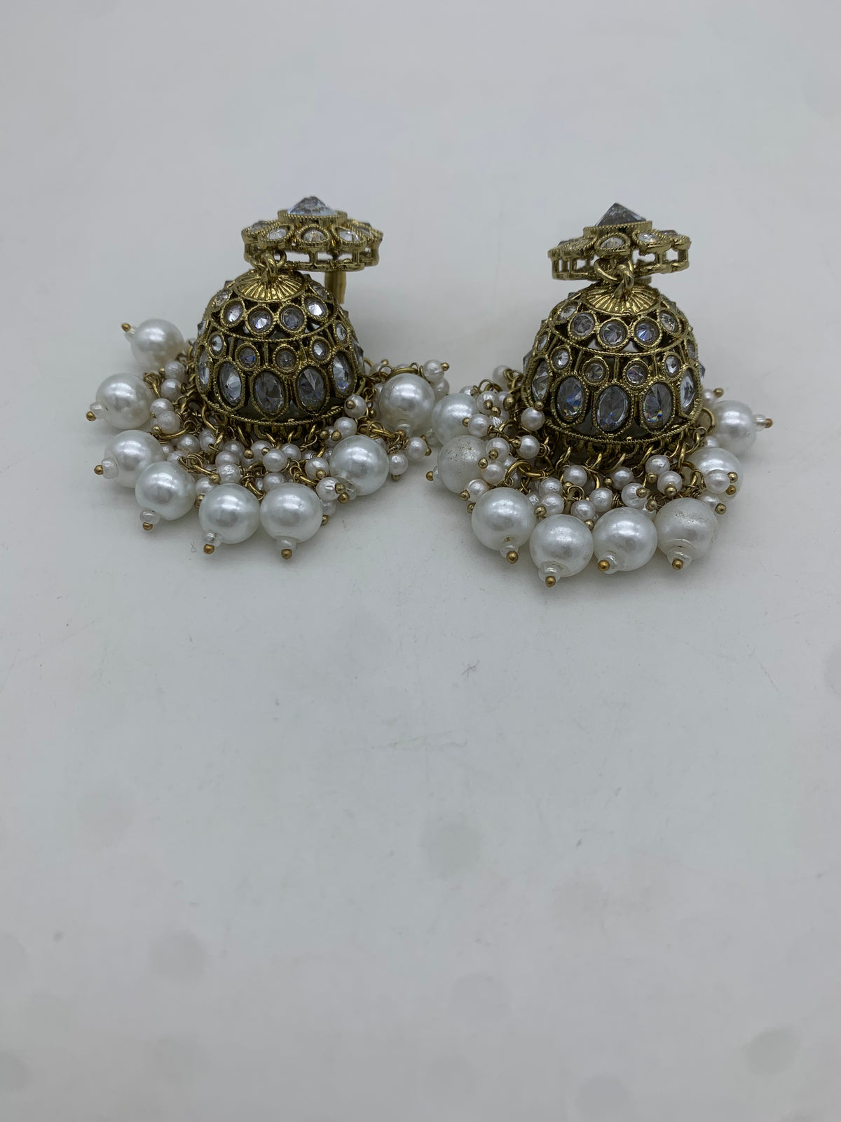 Gold and white jhumka earrings